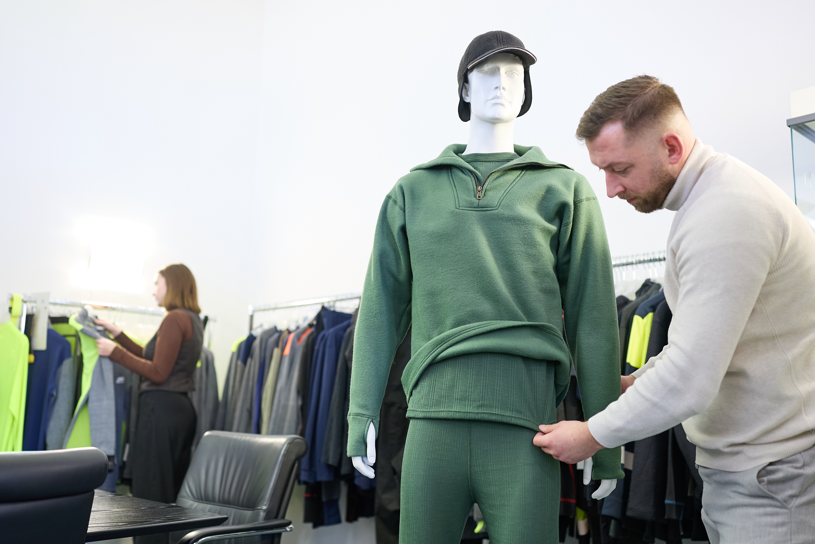 Store mannequins wearing protective underwear. Man dressing mannequin.