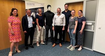 People standing in front of wall. 