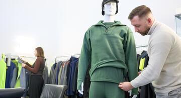 Store mannequins wearing protective underwear. Man dressing mannequin.