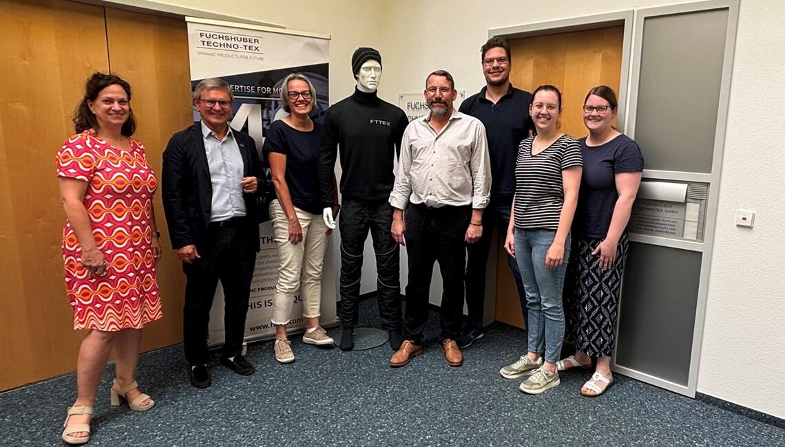 People standing in front of wall. 